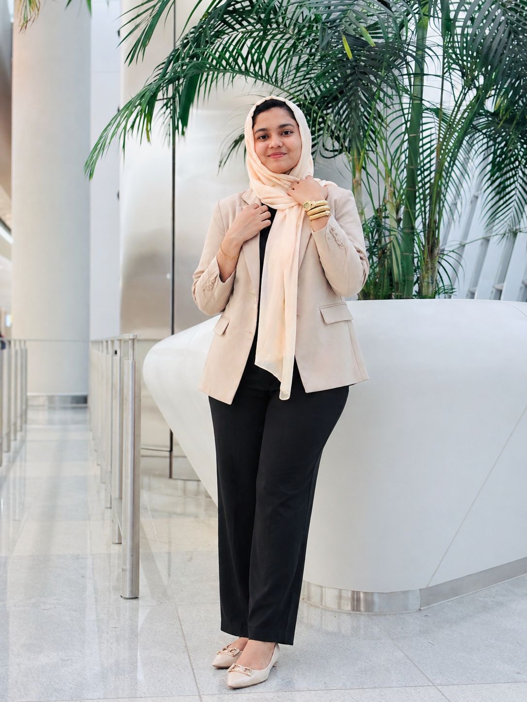 Fiba Nourin standing indoors with greenery